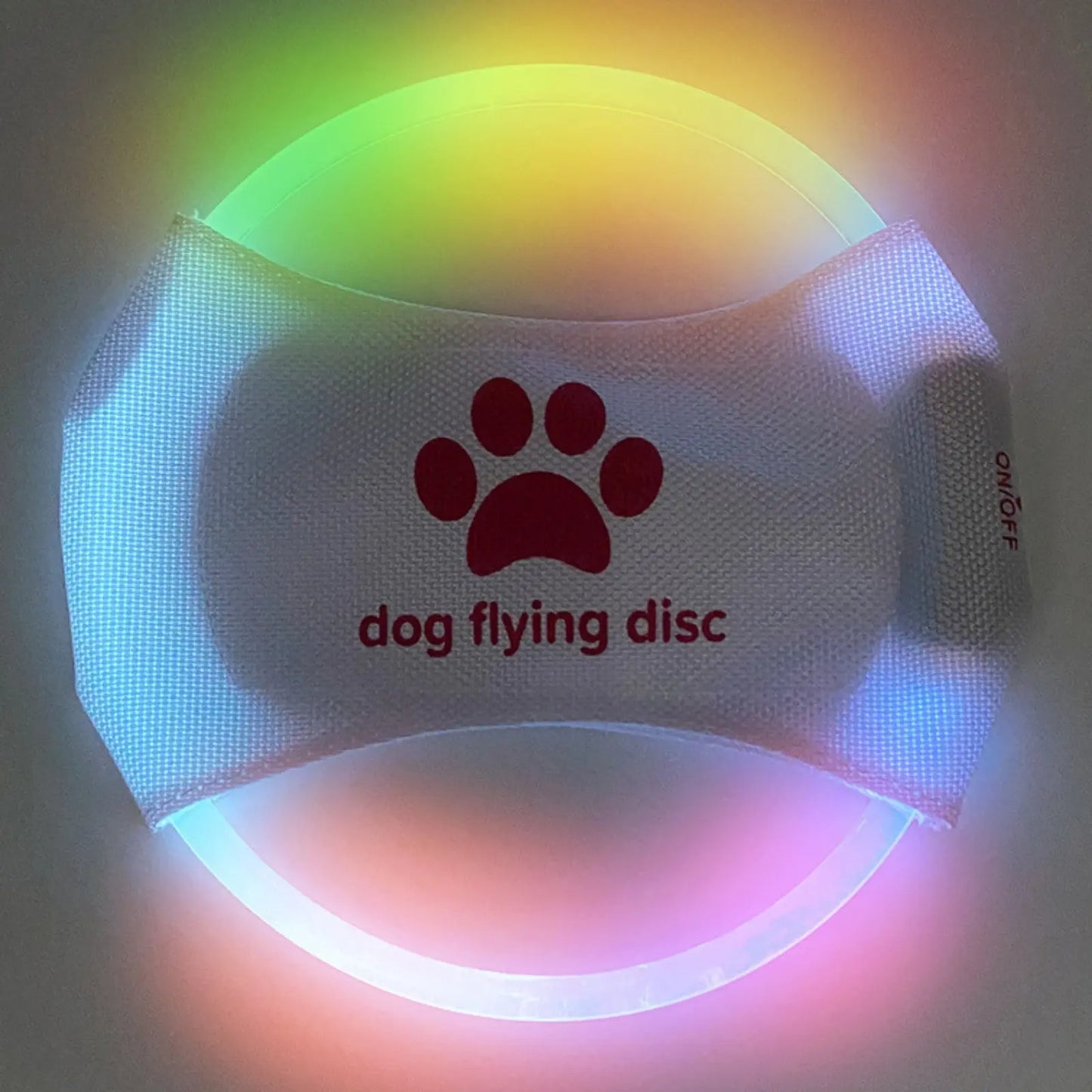 Colorful LookPaw™ rechargeable LED flying disc with paw design glowing