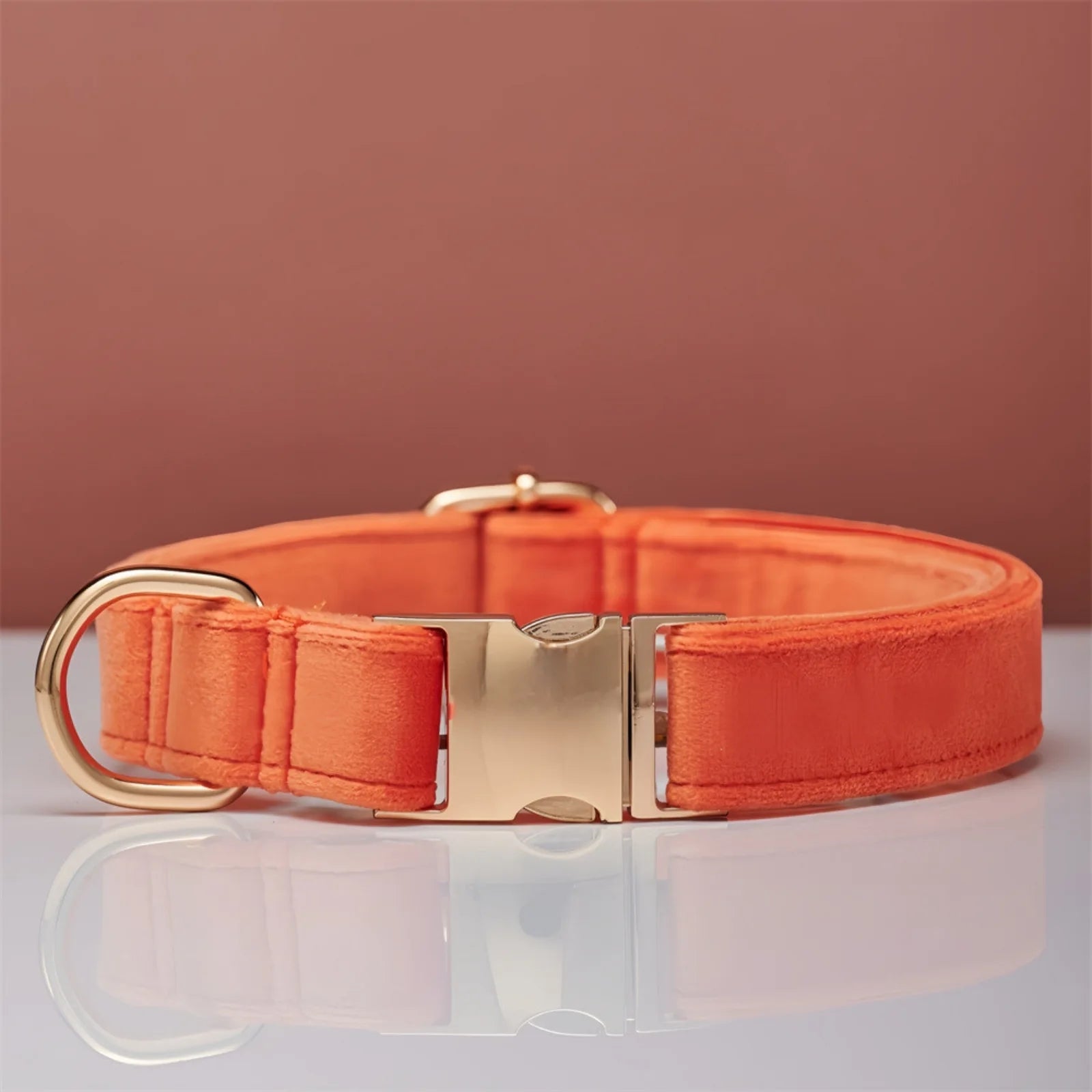 Stylish pastel coral color dog collar displayed on table