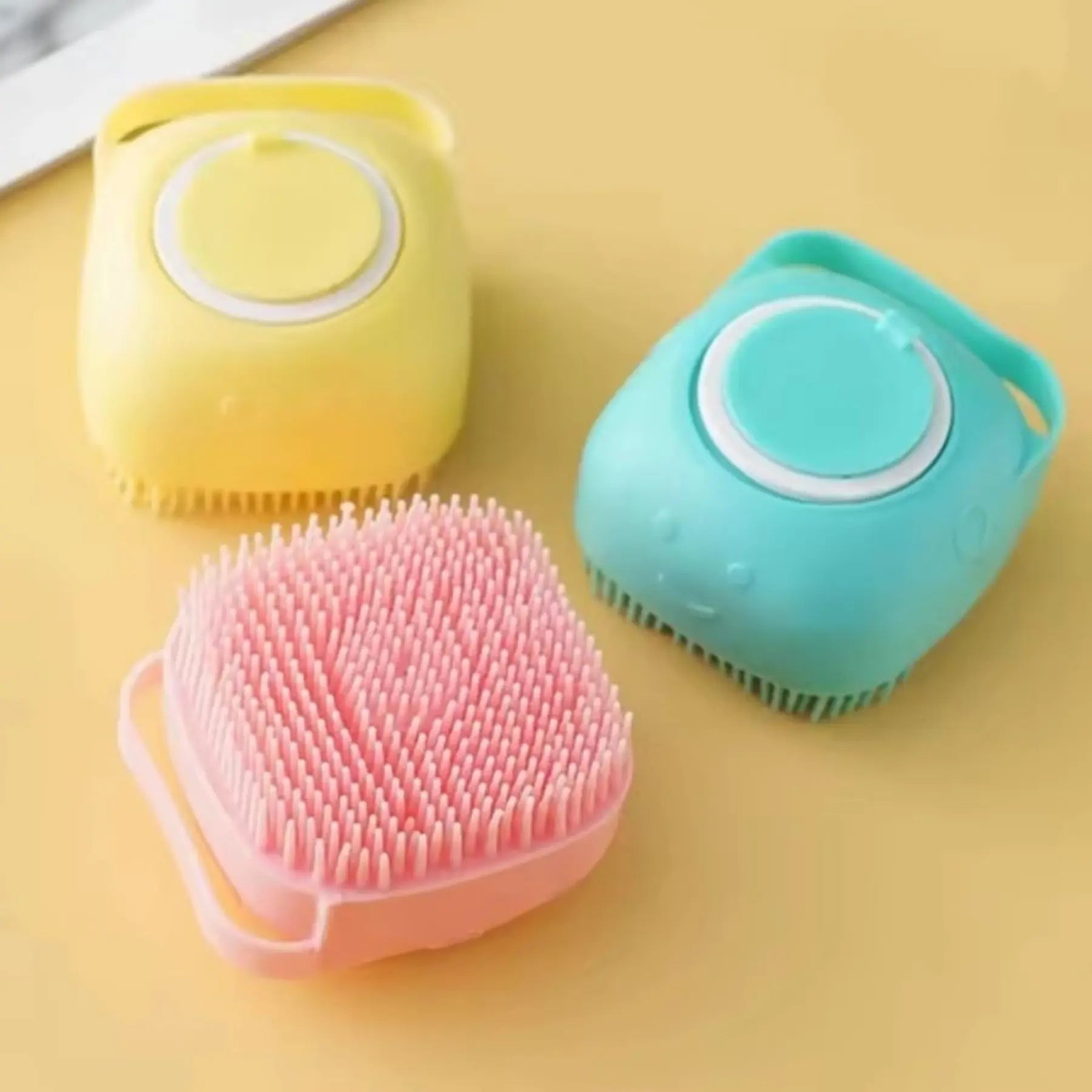 Yellow, pink and green 2-in-1 silicone grooming brushes for pets