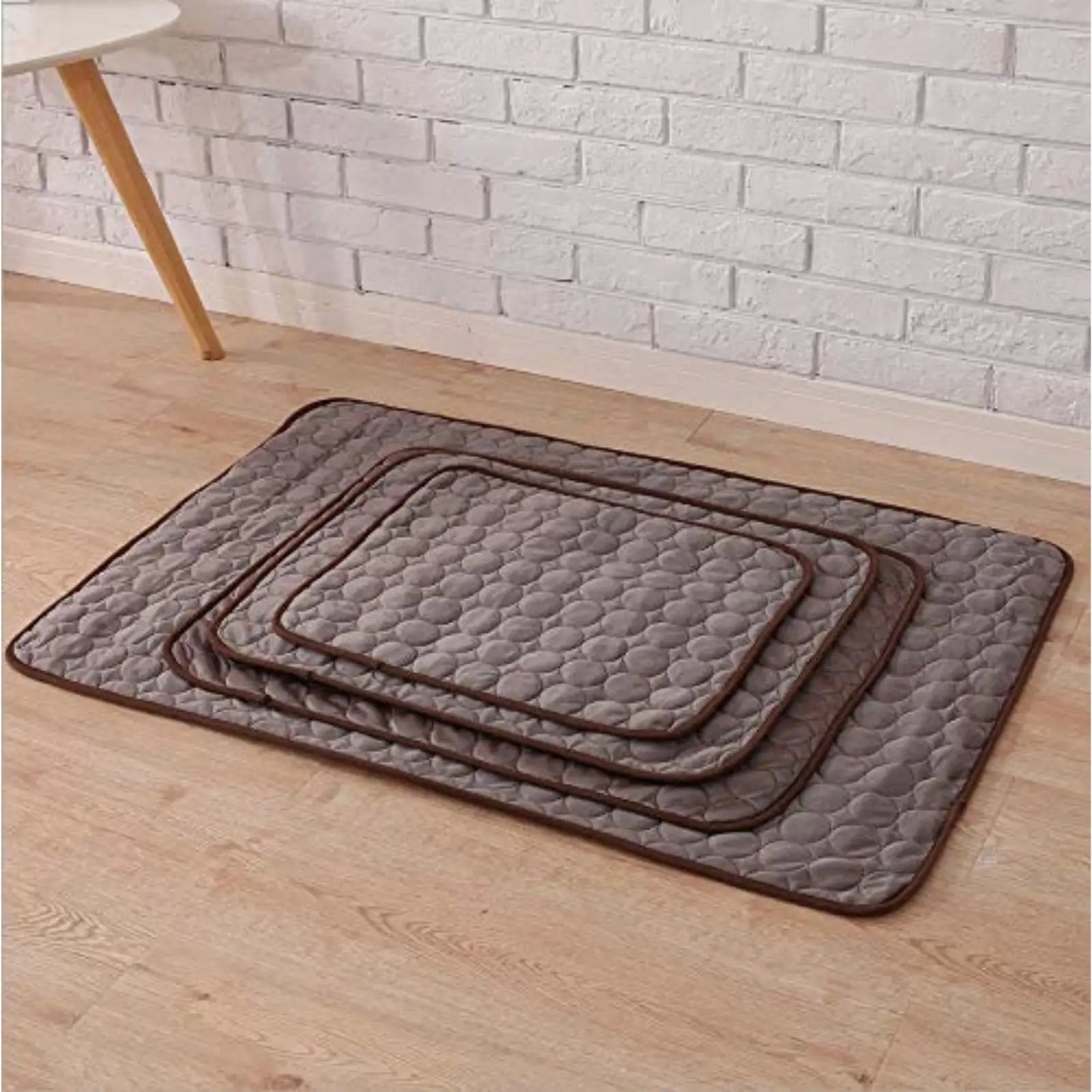 Stacked ChillPaw brown cooling mats in multiple sizes