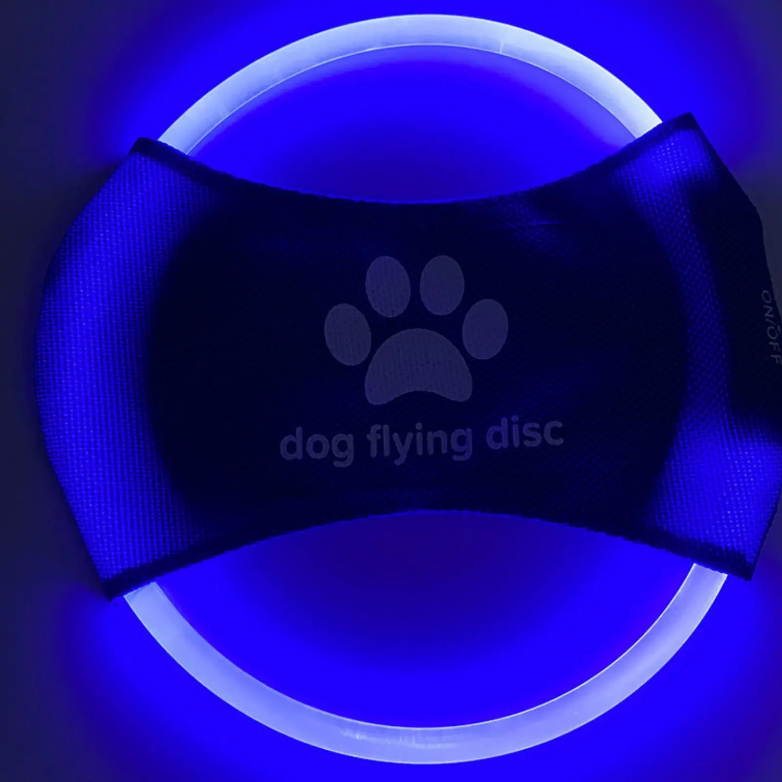 Blue LookPaw™ rechargeable LED flying disc glowing at night